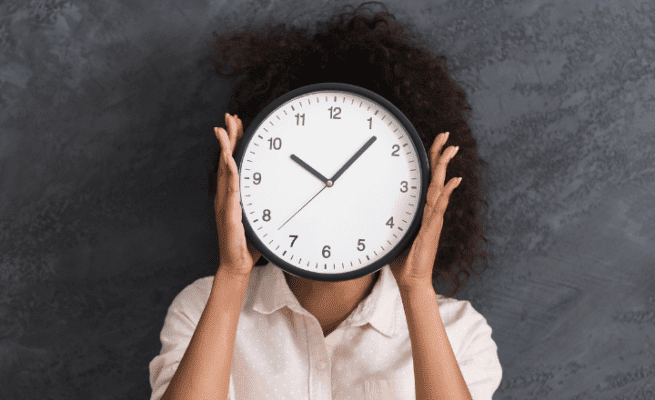 Woman holding watch. Time management for the Modern Workplaces